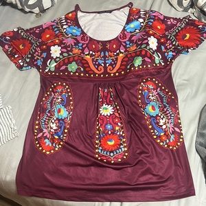 It’s a XL off the shoulder tank top very colorful and the brand is Noracora .